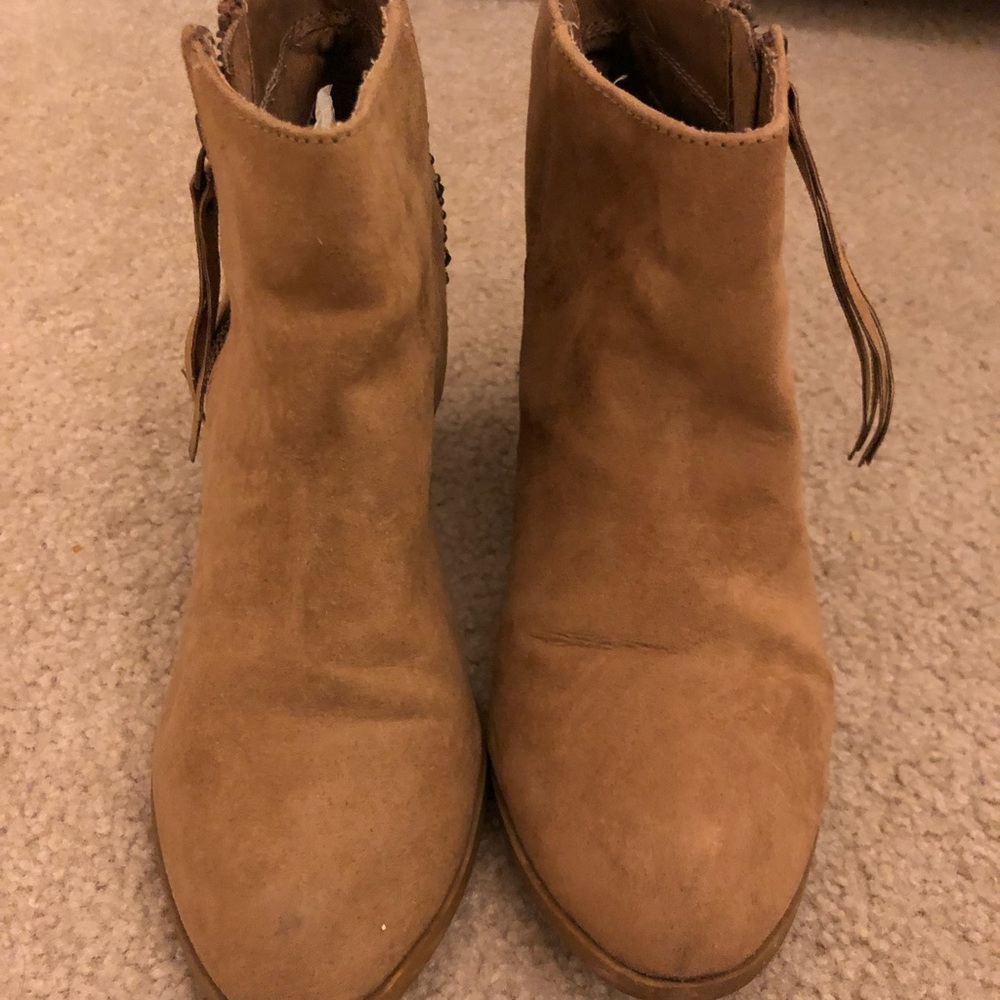 Tan suede heeled boots.
